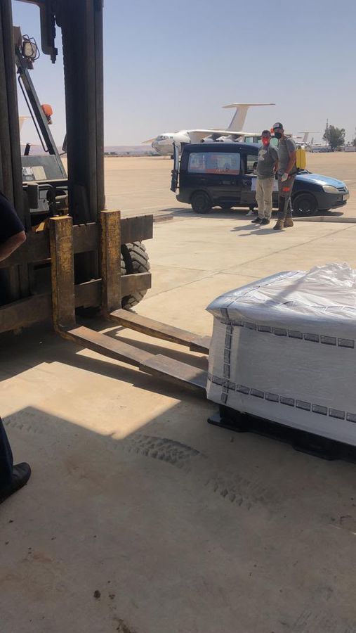 Forklift lifting a cargo pallet on the apron
