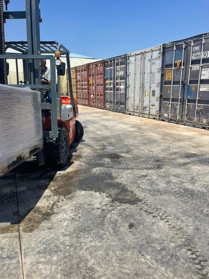Forklift working along the container row