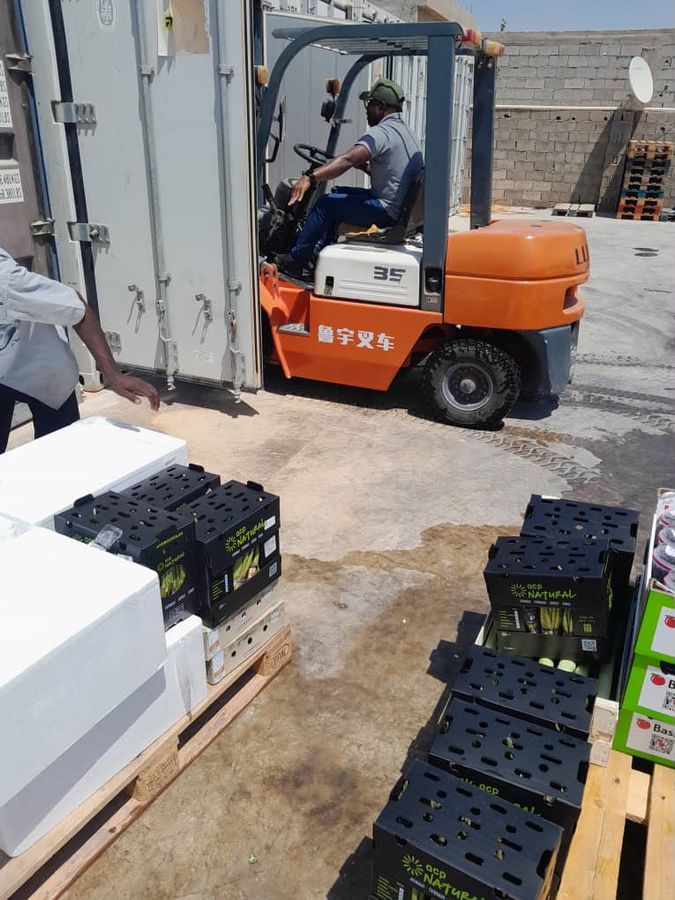 Forklift handling fresh produce crates