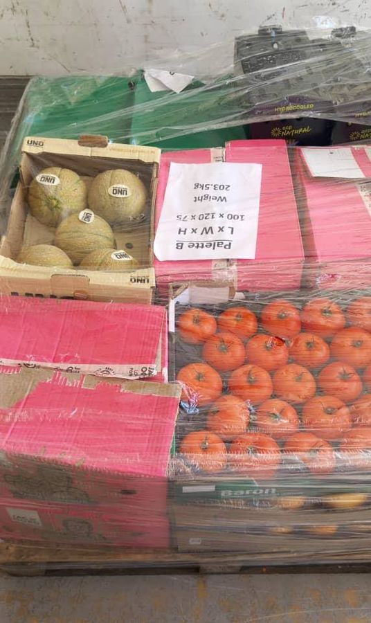 Fresh melons and tomatoes on a pallet