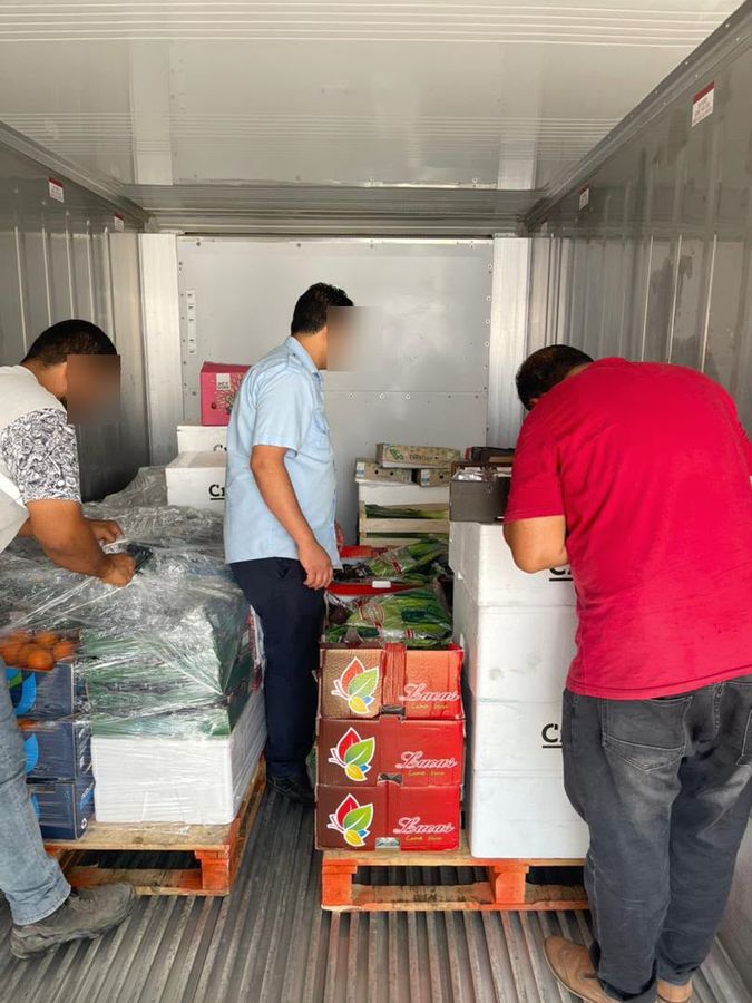 Team unloading fresh produce from the truck
